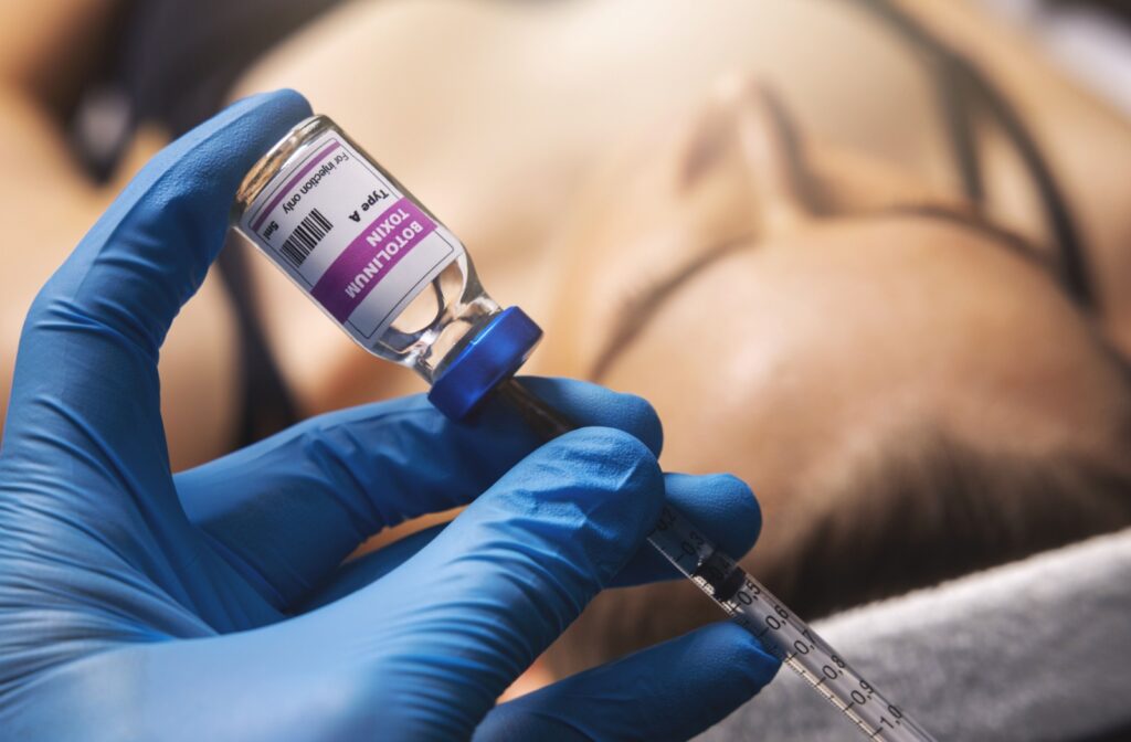 A close-up image of a dermatologist preparing a needle with the Botox injectable.